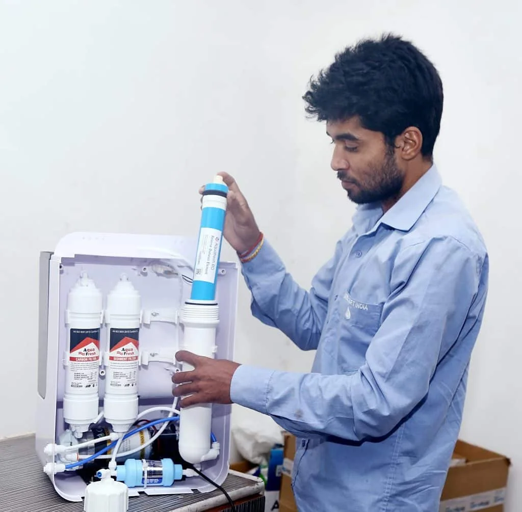 technician replacing RO spare parts in kitchen